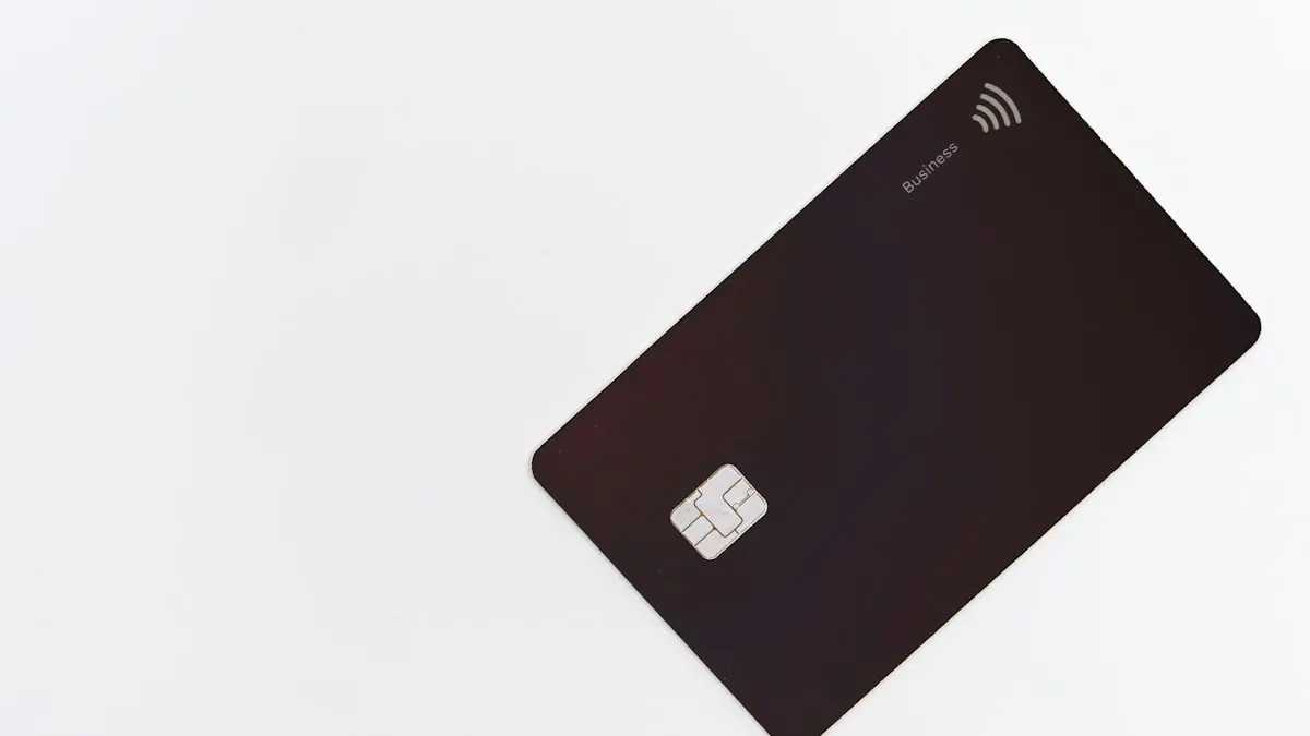 A hooded figure at a computer in low light, representing dark web credit card fraud operations